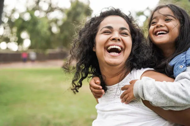 Masi and niece sharing a close family bond while smiling together outdoors
