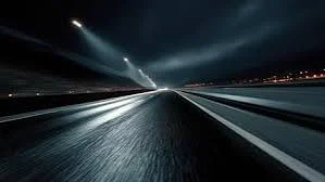 Short Night Ride Captions for Instagram displayed with a peaceful midnight road and glowing headlights